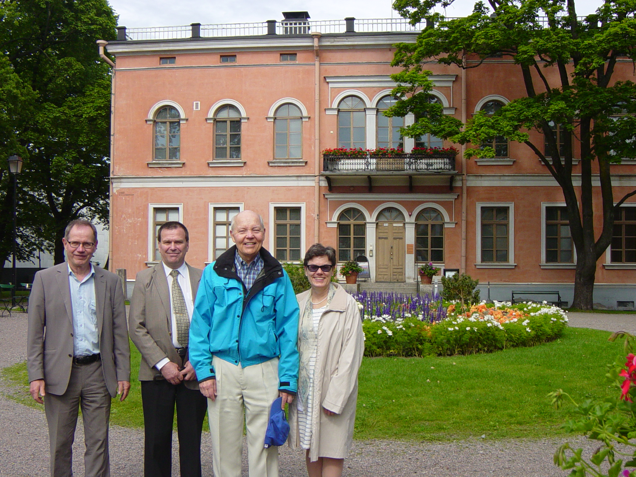 John A. Koskinen with his tour guides in a picture taken in front of a house previously owned by a Finnish woman who went to Siberia to make her fortune by marrying wealthy men.